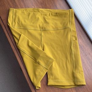 Athleta mustard workout shorts, 6in, inside pocket.